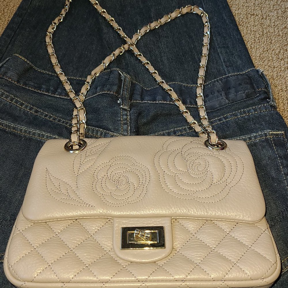 Tan colored Genuine Leather purse with adjustable shoulder strips.